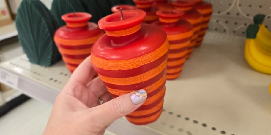 hand holding vase candle