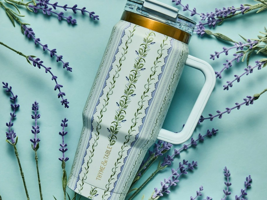blue botanical tumbler laying with lavender