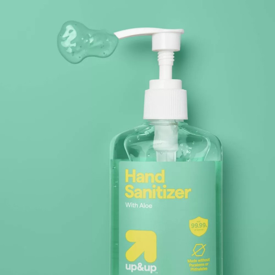 up and up hand sanitizer bottle on green background