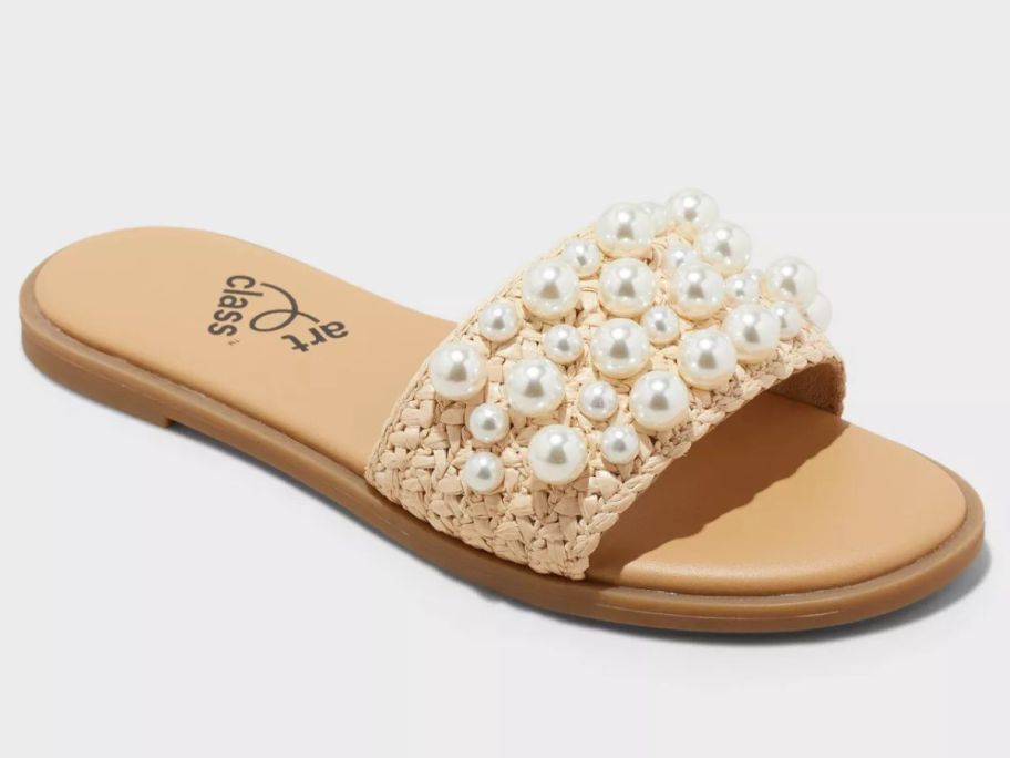 A brown sandal with beaded embellishments
