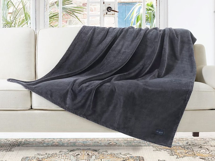 dark grey throw blanket draped over couch