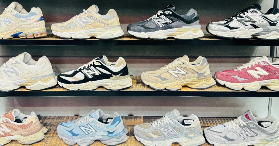 a store wall display filled with different types and colors of New Balance adult's running shoes