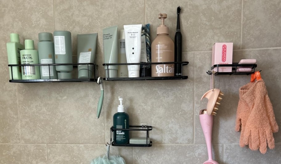 shower caddy shelves hanging on shower wall with toiletries 
