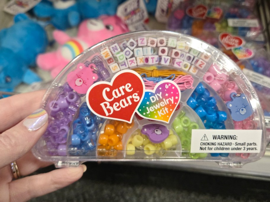 hand holding Care Bears jewelry kit