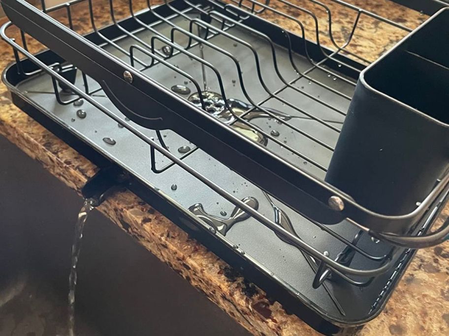 Kitsure Dish Drying Rack with drain spout draining water into sink
