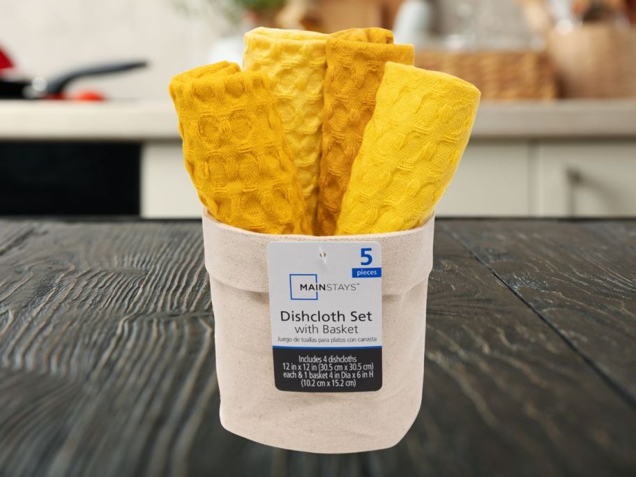 yellow dishcloths in beige basket on counter