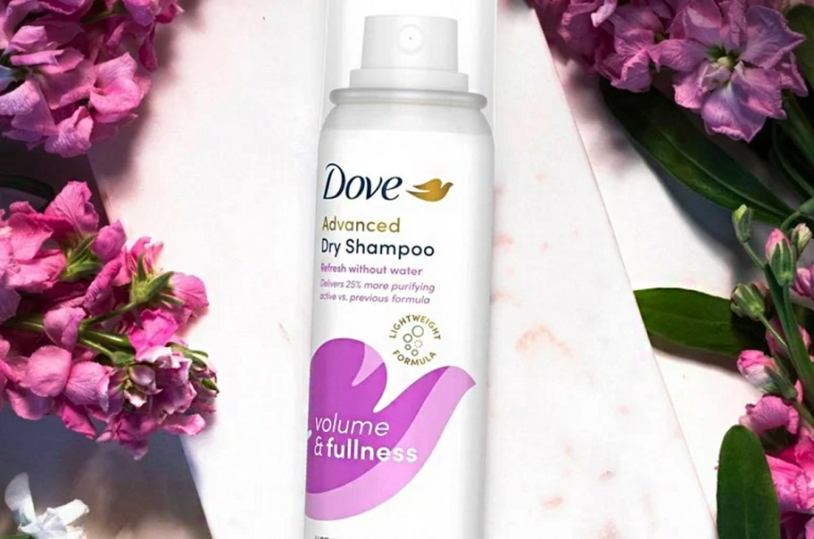 dove dry shampoo bottle near flowers