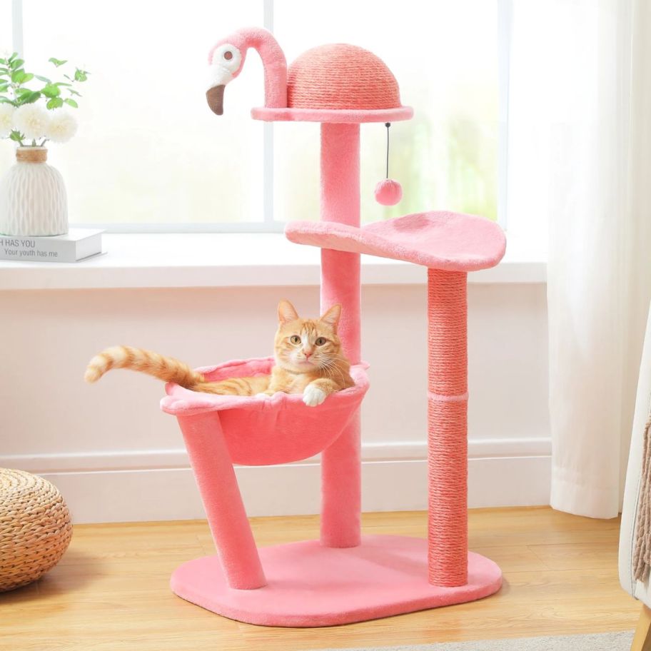 flamingo themed cat tree with a cat on it