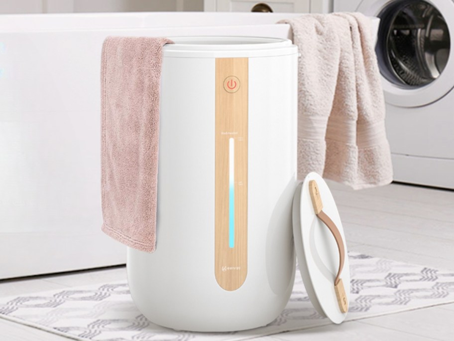 a towel warmer with towels in it by a bathtub