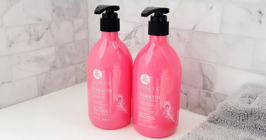 shampoo and conditioner in pink bottles by bathtub