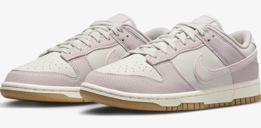 a pair of white and light purple women's Nike Dunk sneakers