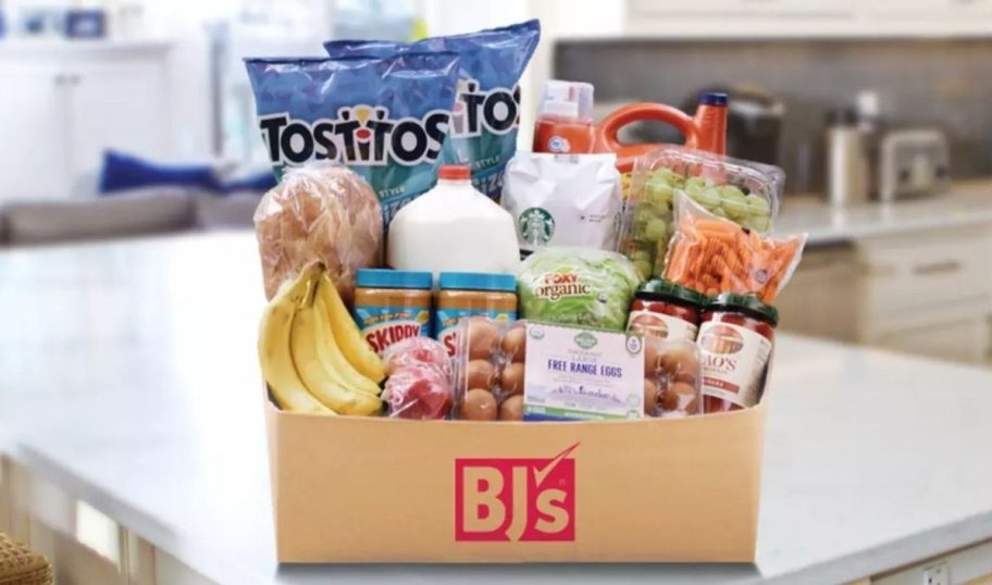 a box of groceries sitting on an island in a kitchen