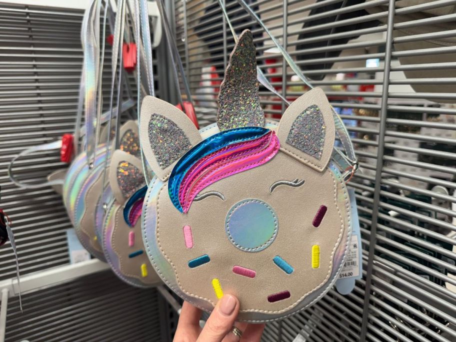A person holding a Cat & Jack Girls Unicorn Donut Crossbody