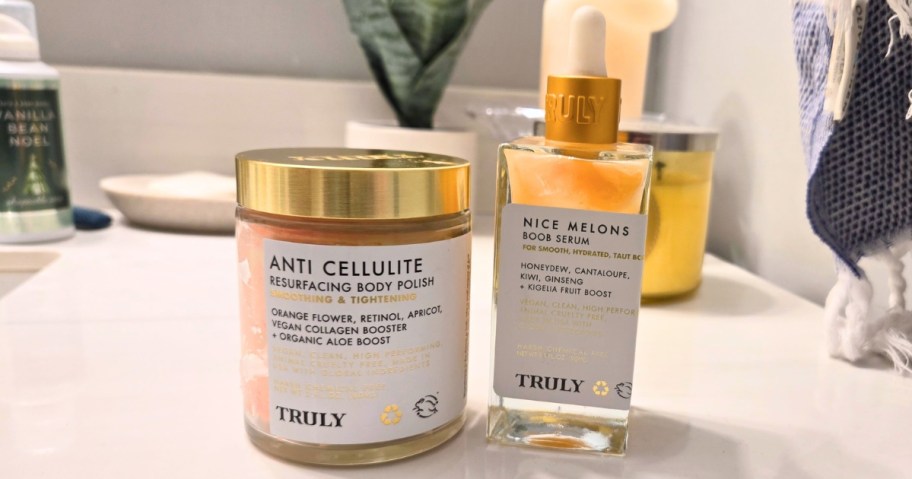 a jar and bottle of Truly brand body care treatments