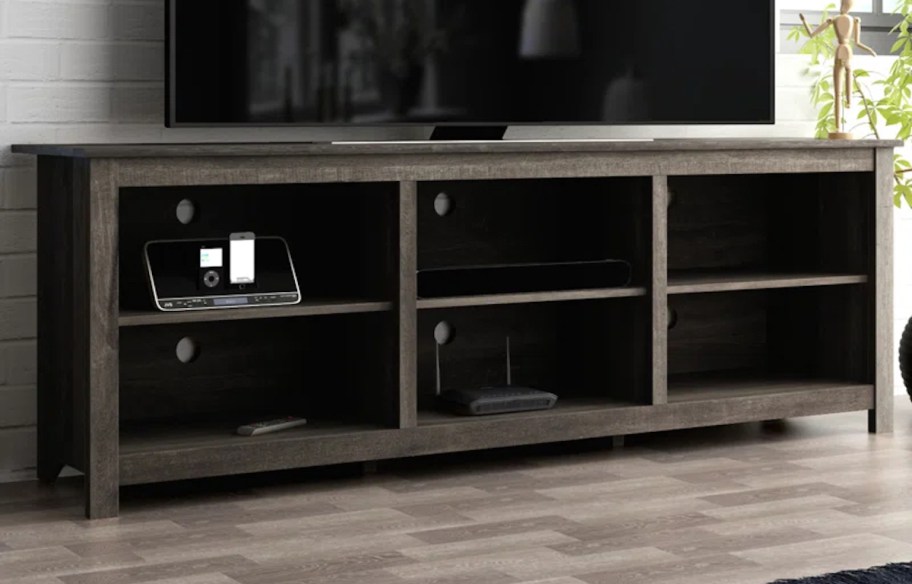 dark brown tv console stand table with flat screen above it in living room