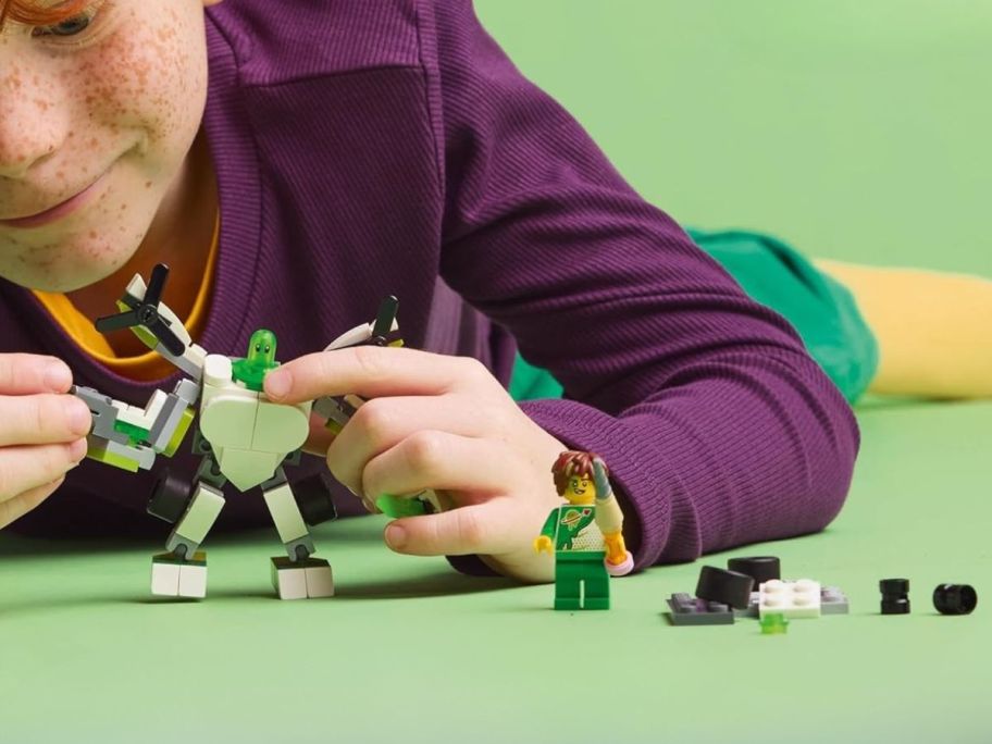 boy playing with LEGO DREAMZzz X-Blob's Robot & Vehicle Adventures Robot