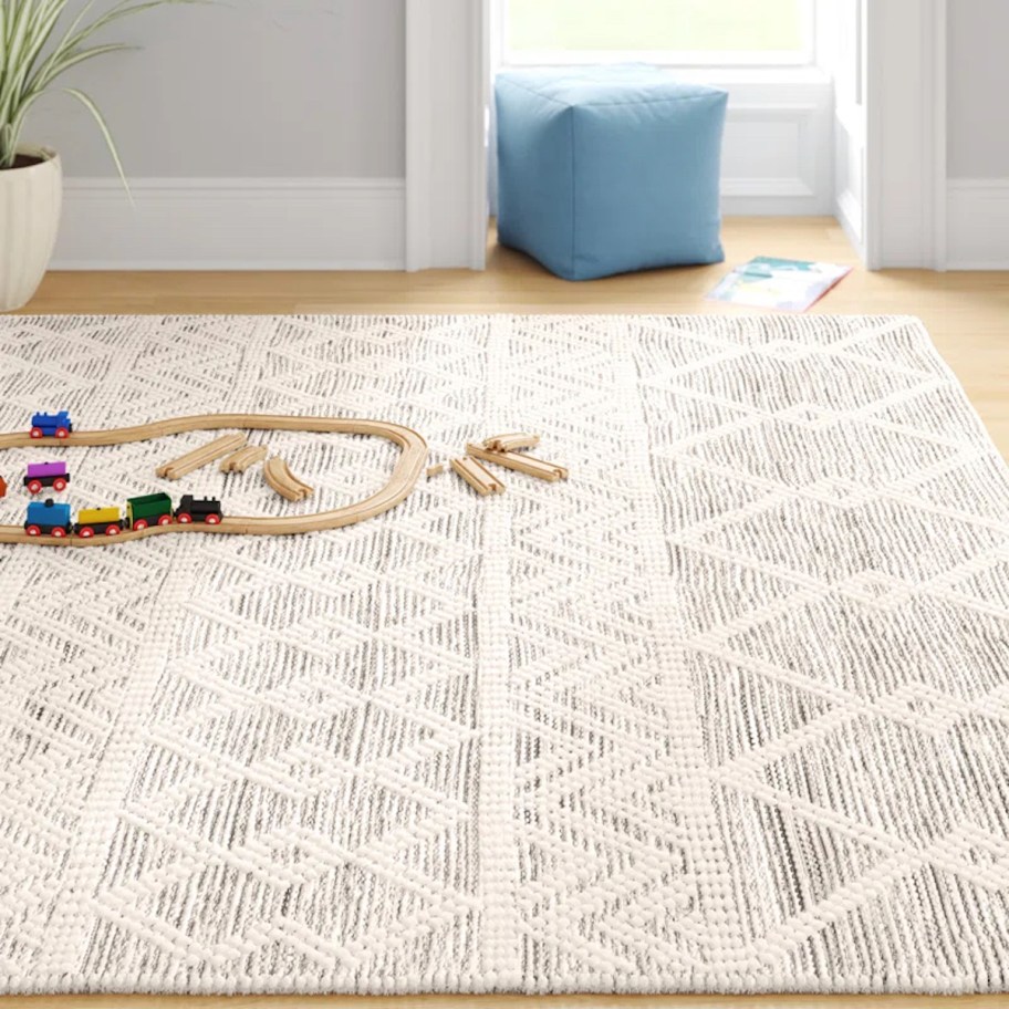 wool rug on floor with wooden toy train