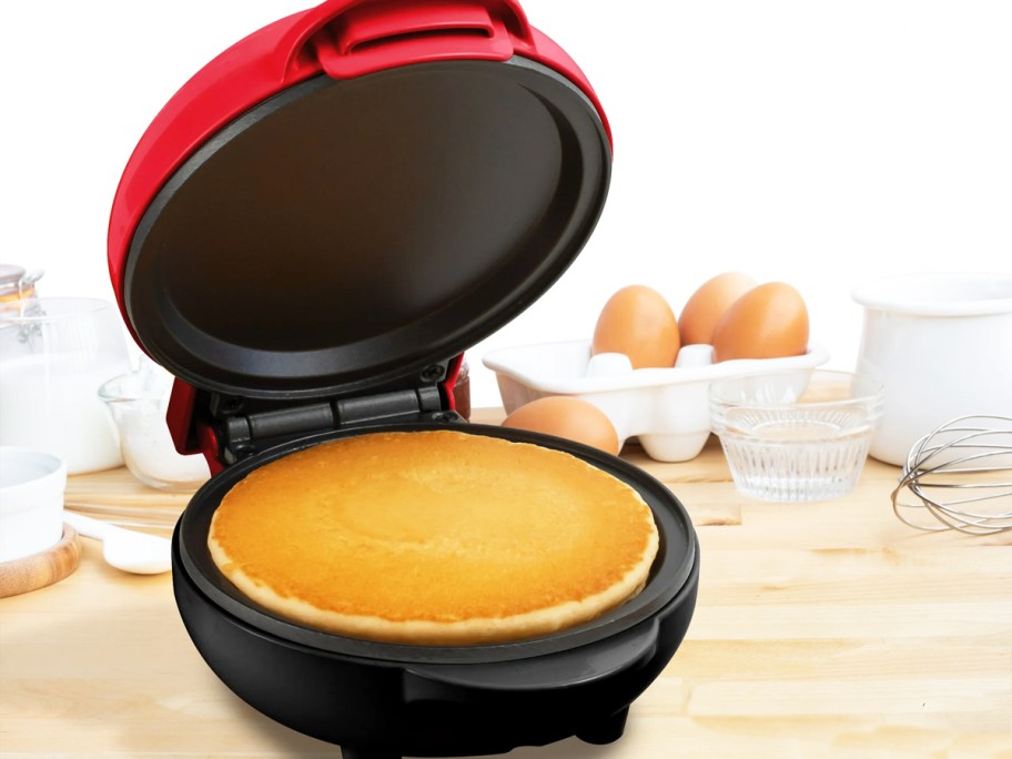 pancake in a red and black griddle
