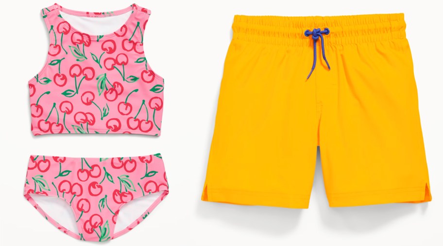 cherry print bathing suit and orange swim trunks