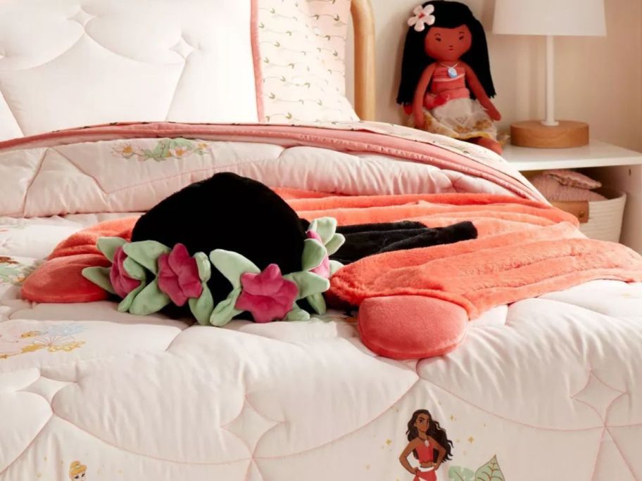 Pillowfort Disney Princess Moana Hooded Throw Blanket on a bed