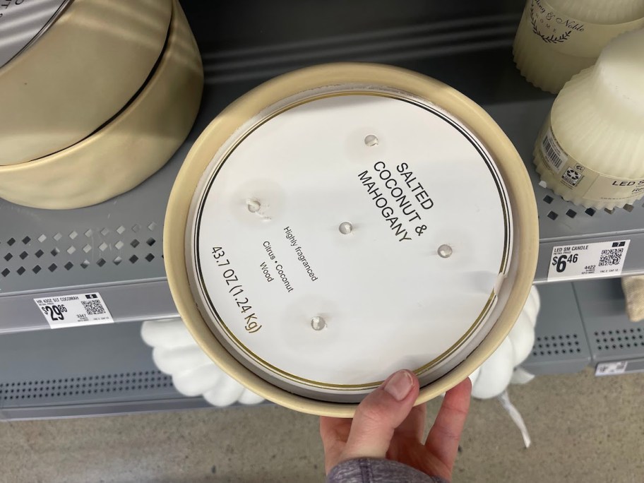 hand holding circle 5 wick candle from store shelf