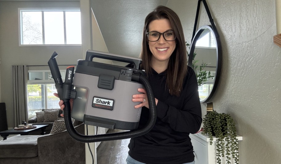 woman holding shark messmaster vacuum