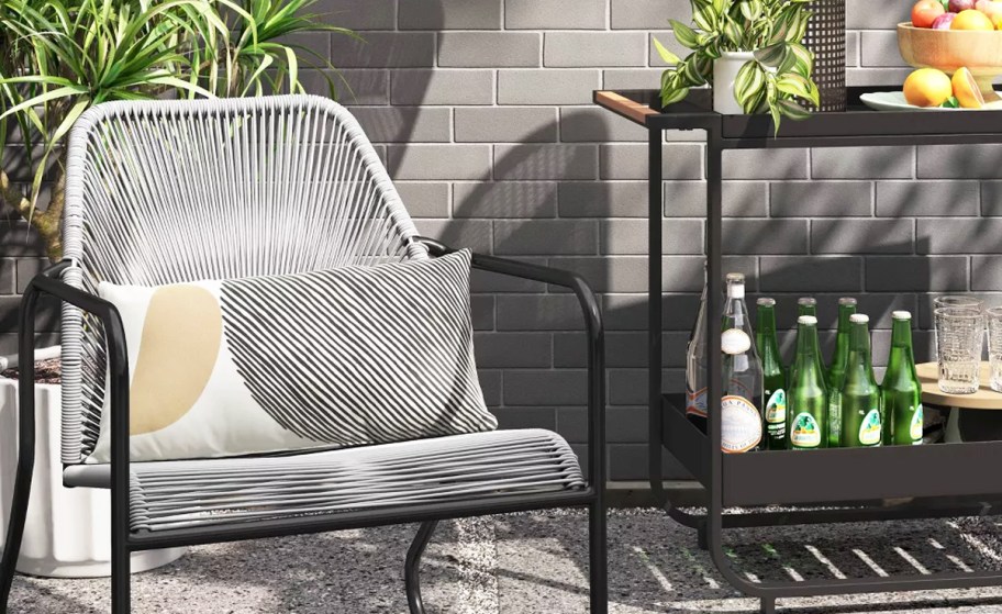 grey patio chair near a bar cart