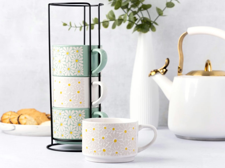 white and green floral stacking mugs on counter