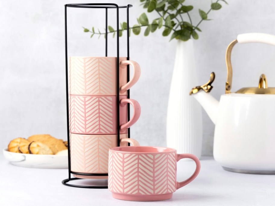 dark pink and light pink stacking coffee mugs on counter