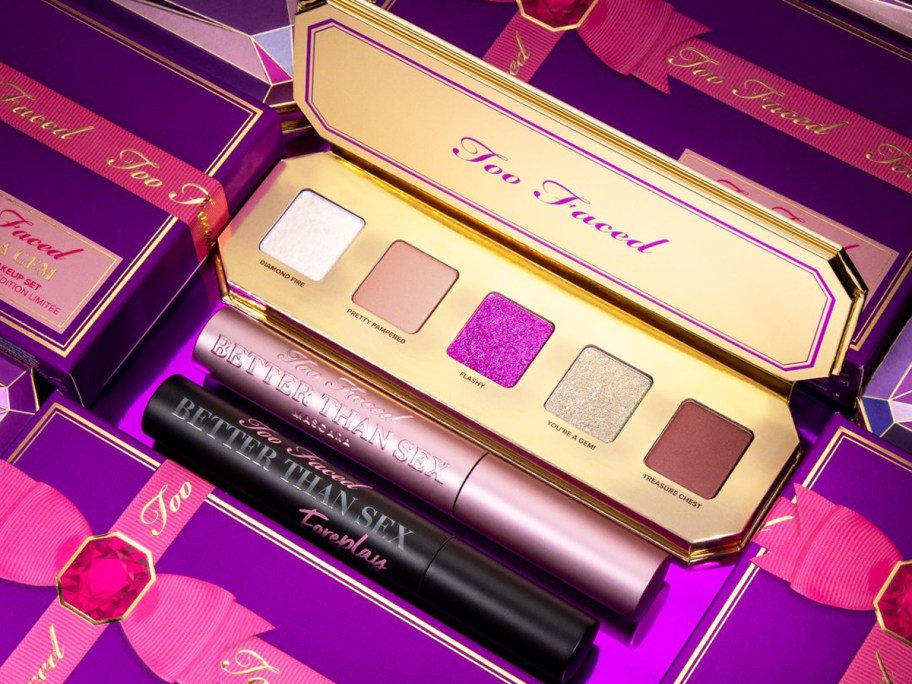 opened eyeshadow palette with two tubes of mascara