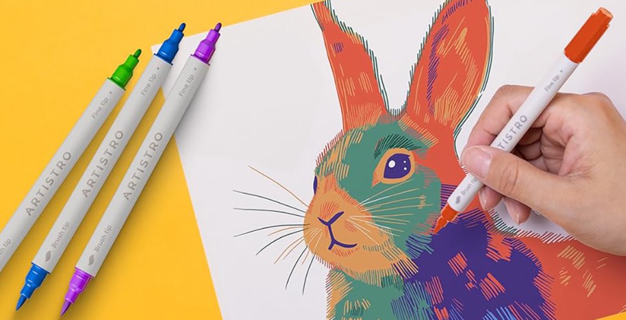 person using dual tipped markers to draw