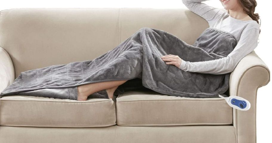 woman laying on couch with grey beautyrest Heated Throw Blanket