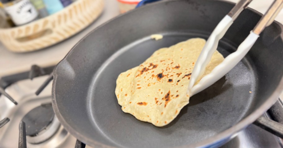 cooking a tortilla on a cast iron skillet