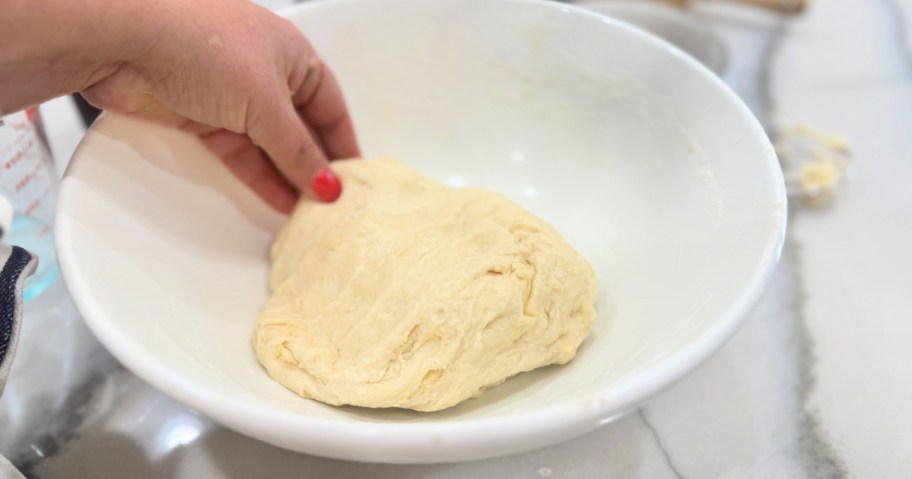 mixing dough in a ball to make tortillas