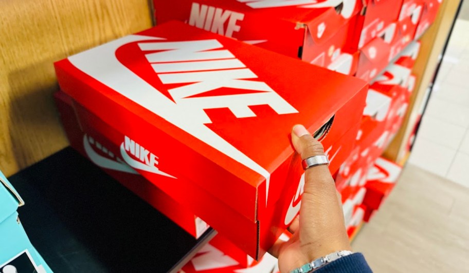 red nike shoe box in hand