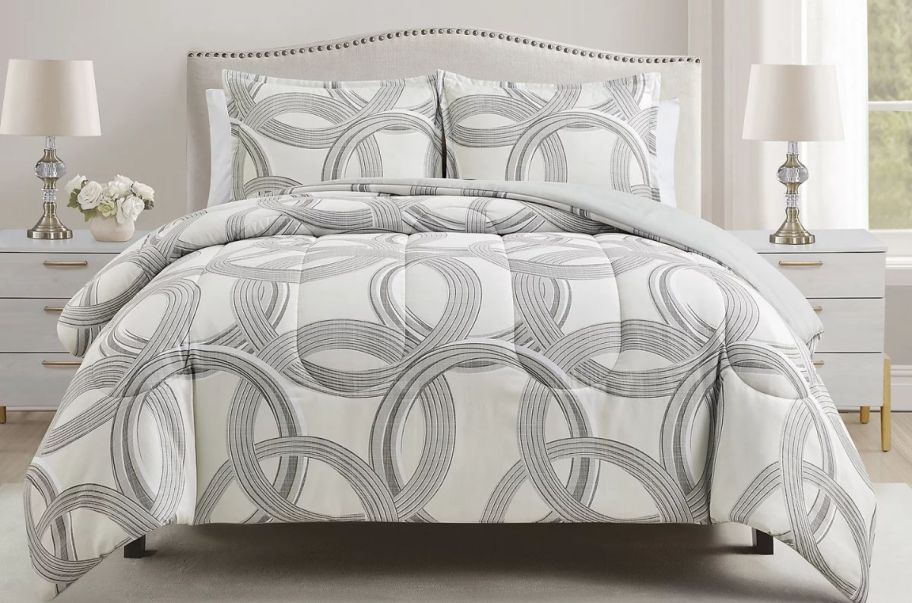 3 piece geometric comforter set on a bed