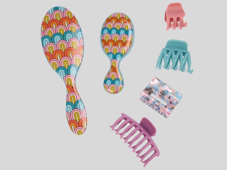 multicolored Wet Brush Endless Summer Rainbow brushes and hair clips against grey background