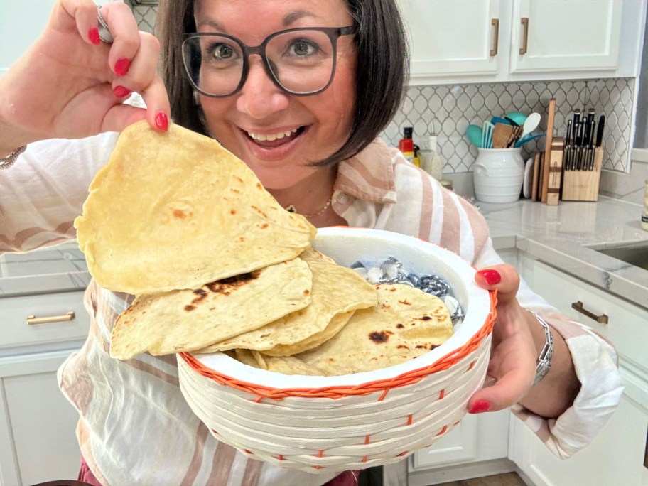 woman holding a basket of homemade flour tortillas 