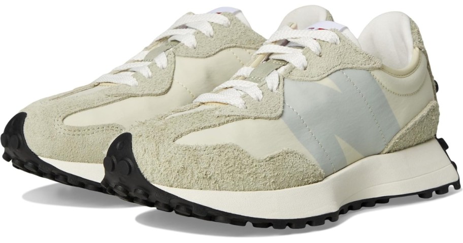 a pair of tan and grey women's New Balance shoes