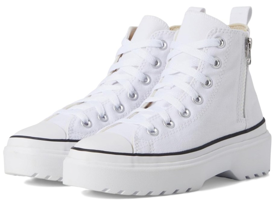 a pair of white platform Chuck Taylor kids shoes
