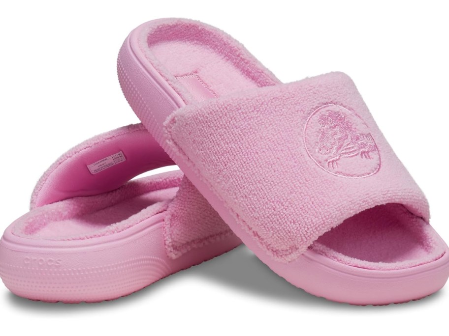 a pair of pink Crocs slides
