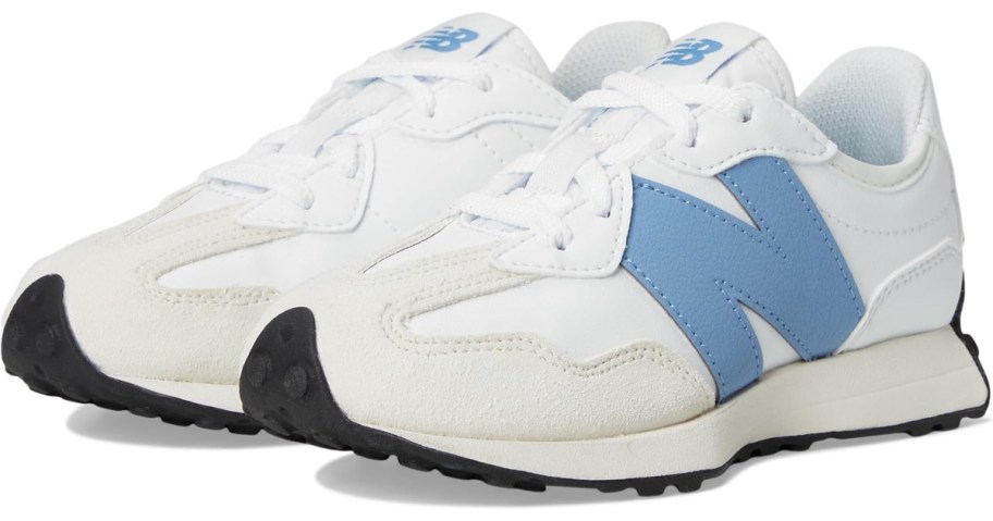 a pair of kids New Balance shoes in white with blue accents