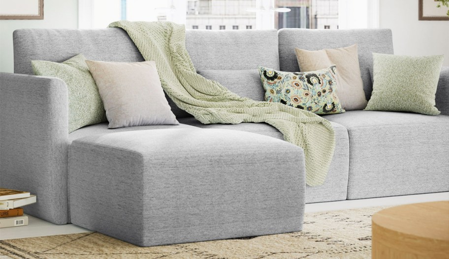 grey sofa with matching ottoman in living room
