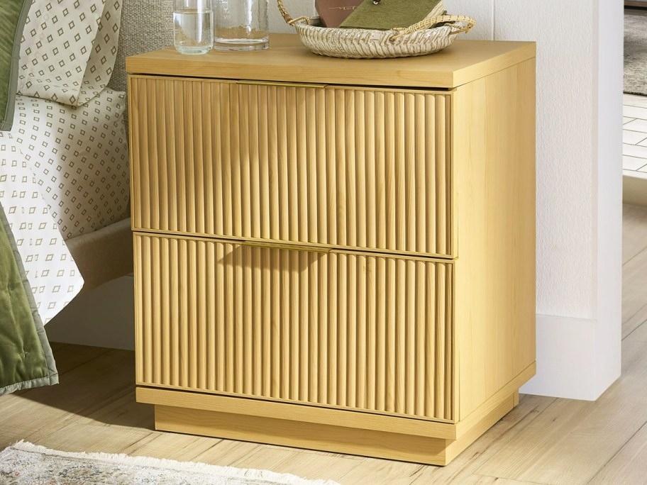 wood 2-drawer night stand next to bed