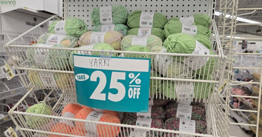 shelves with colorful yarn and a blue sign that says "Take 25% off"