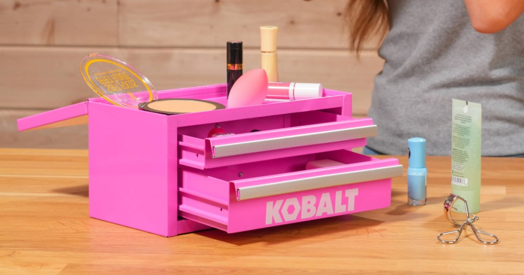 Hot pink, mini toolbox filled with different cosmetic and makeup items