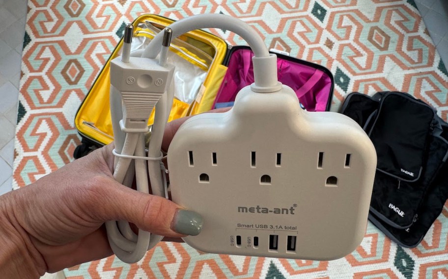 hand holding an International Travel Power Strip 