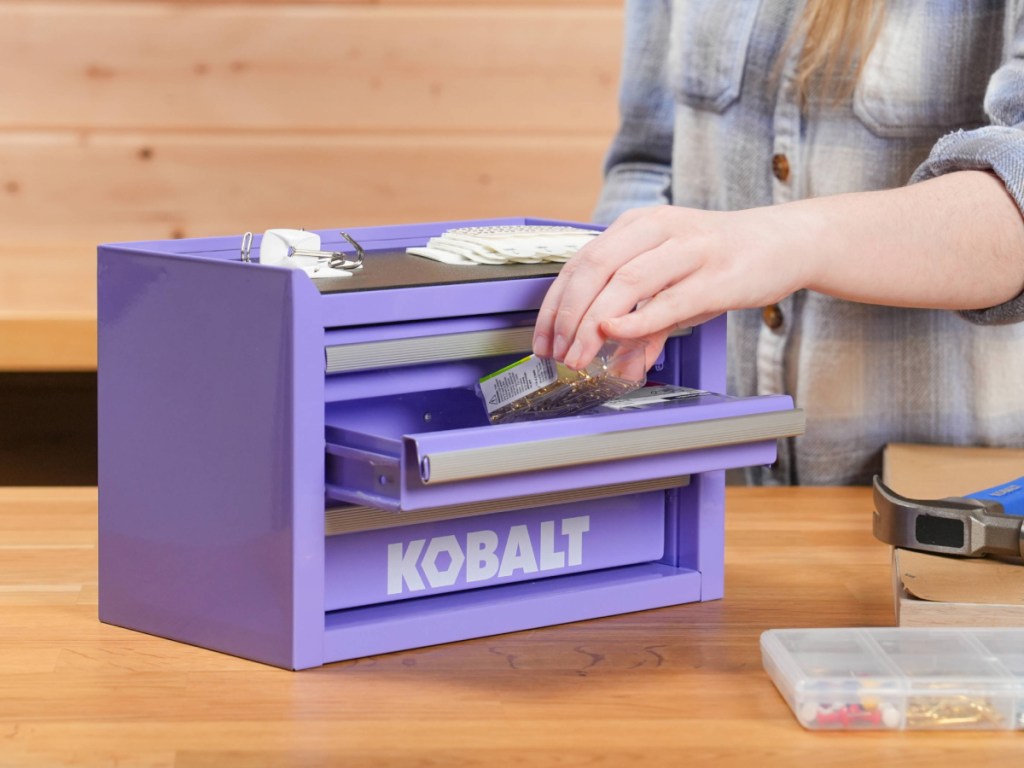  lavender colored mini toolbox with three drawers being filled with crafty items