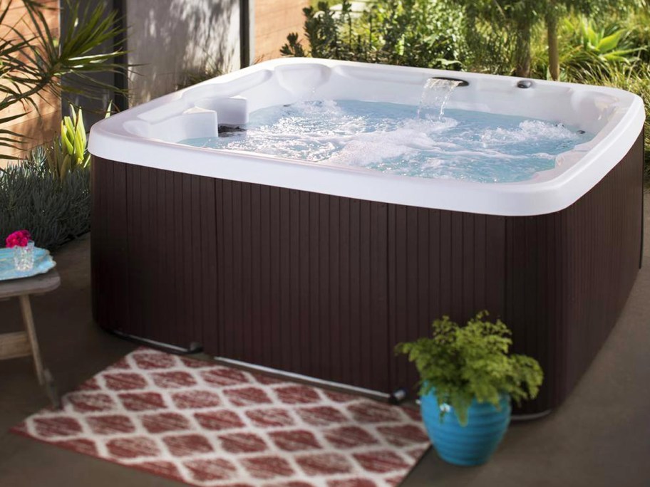 brown square hot tub with waterfall