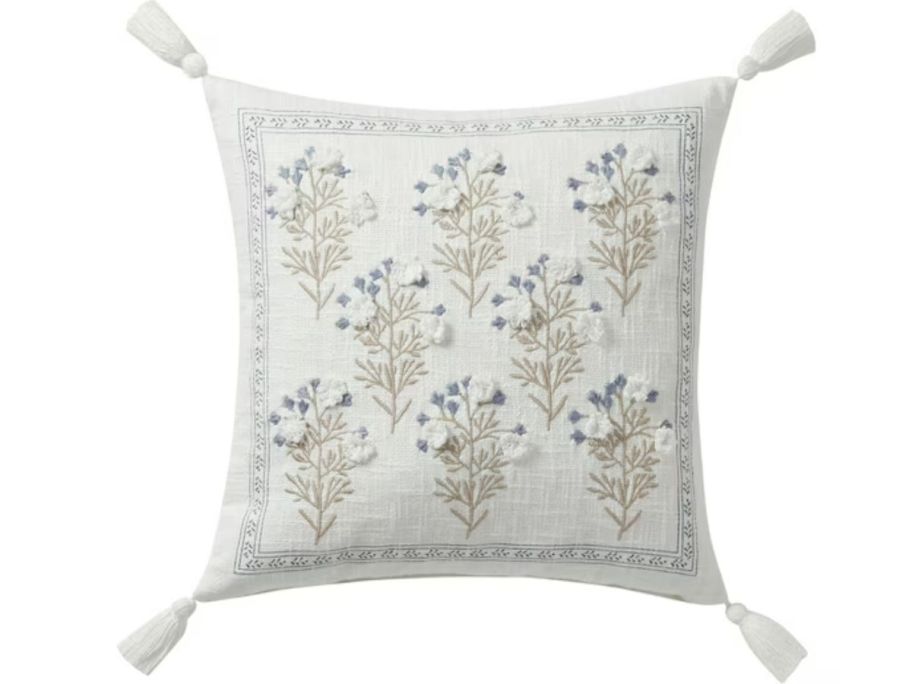 A blue and cream embroidered pillow